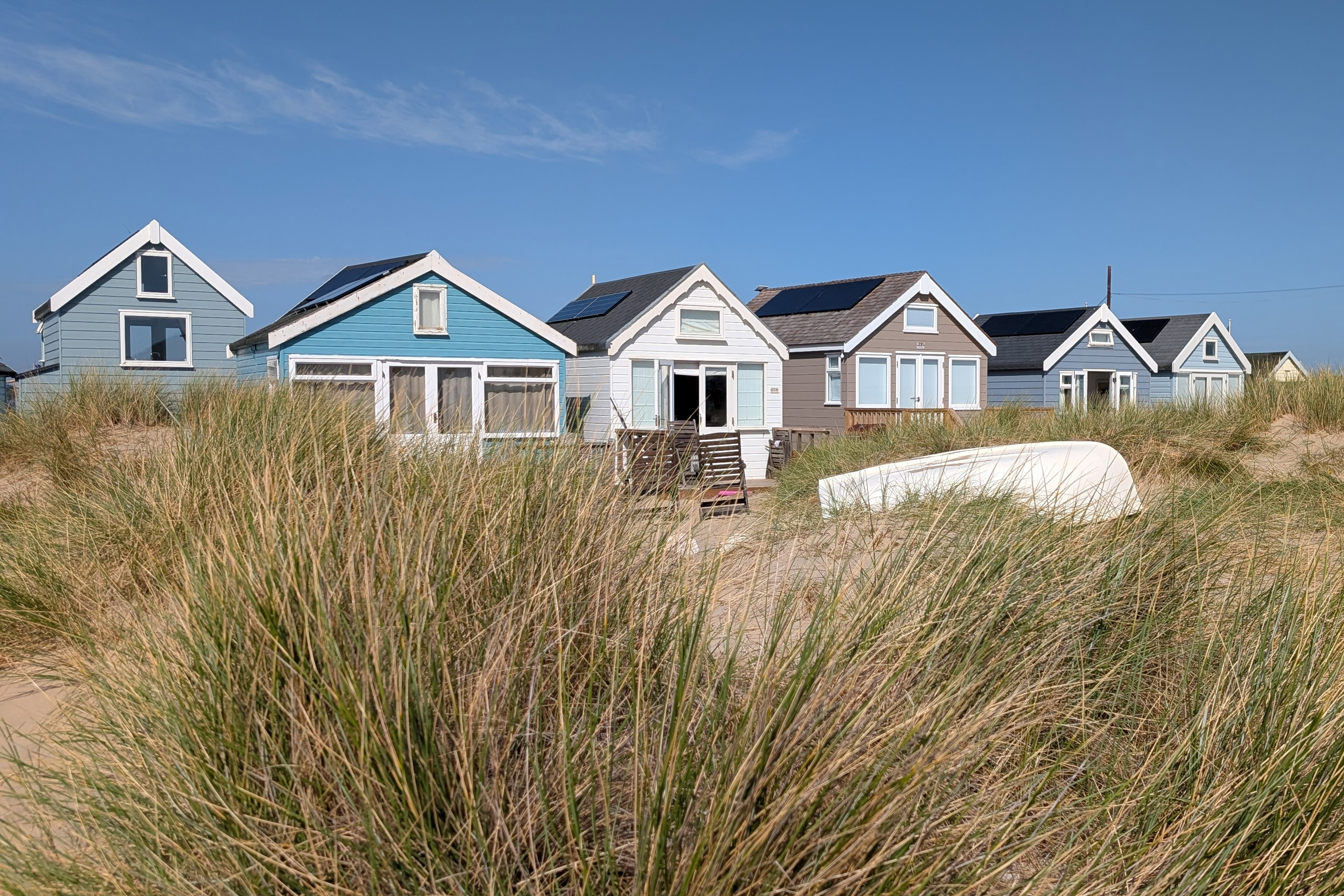 Beach huts line the dunes